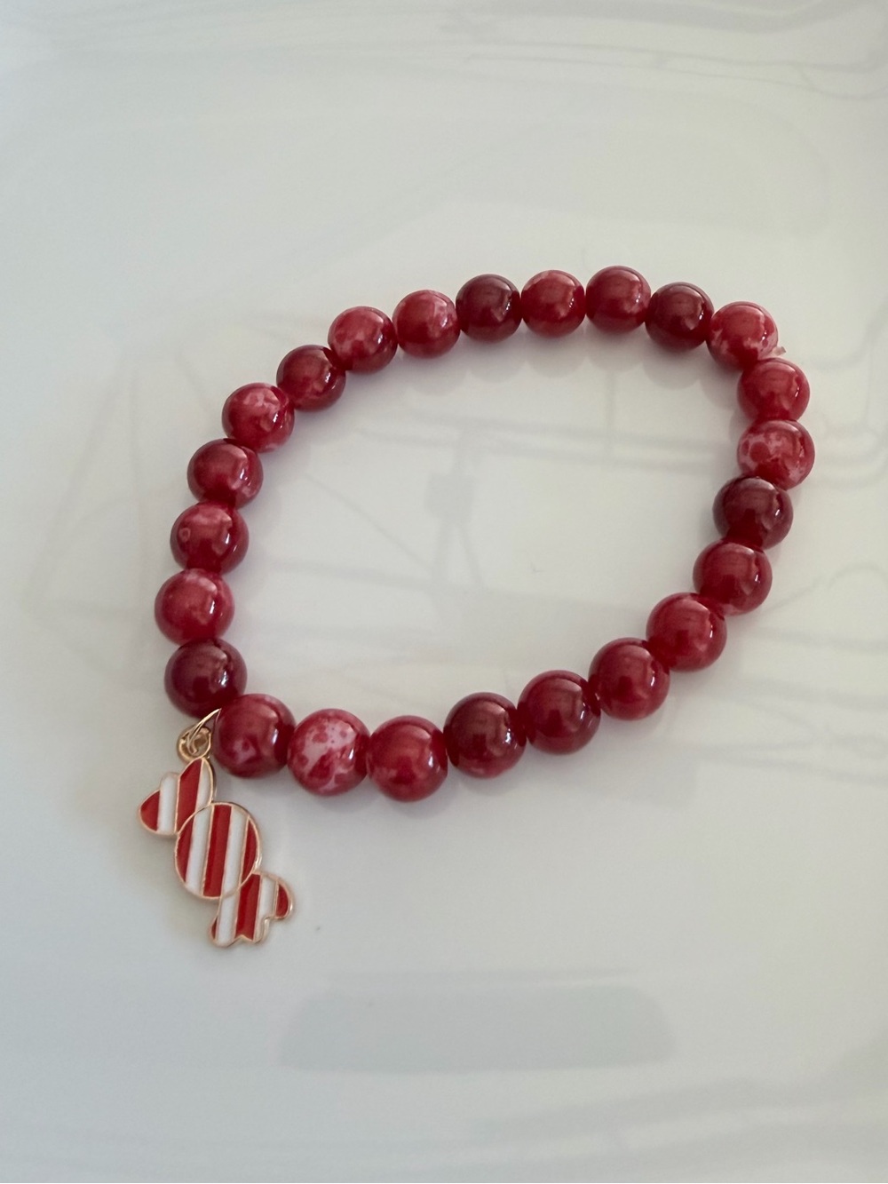 Red Beaded Bracelet with Striped Candy Charm